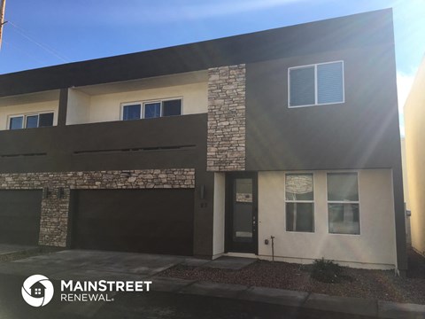 the exterior of a house with a driveway and a garage door